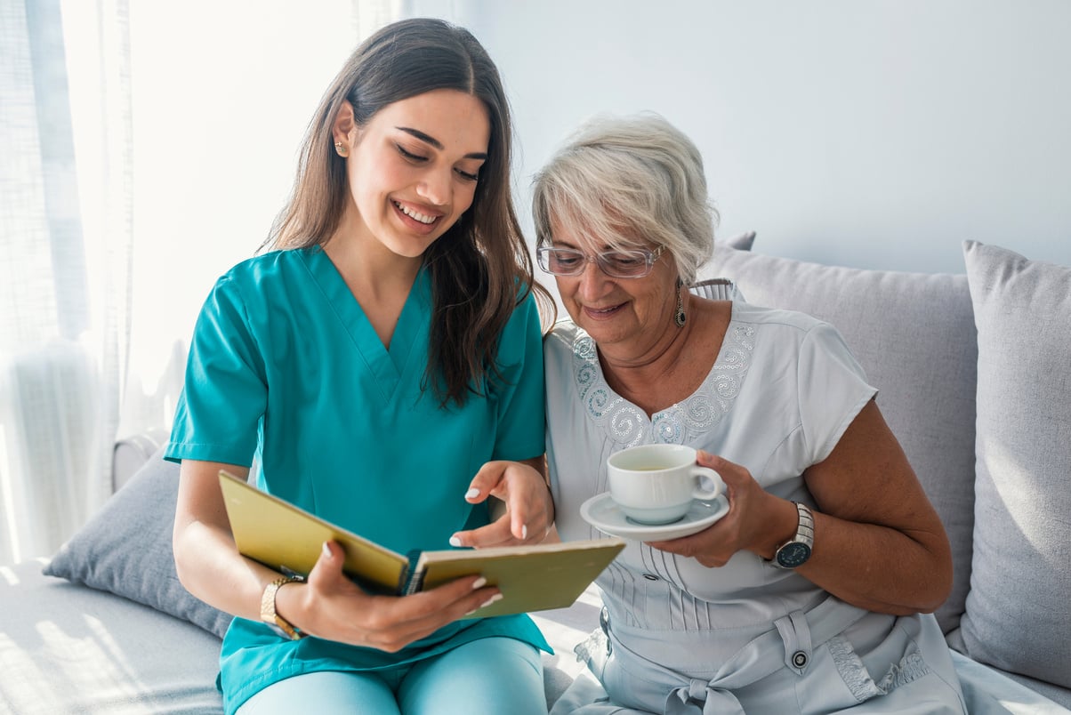 Image of caregiver and senior resting at home