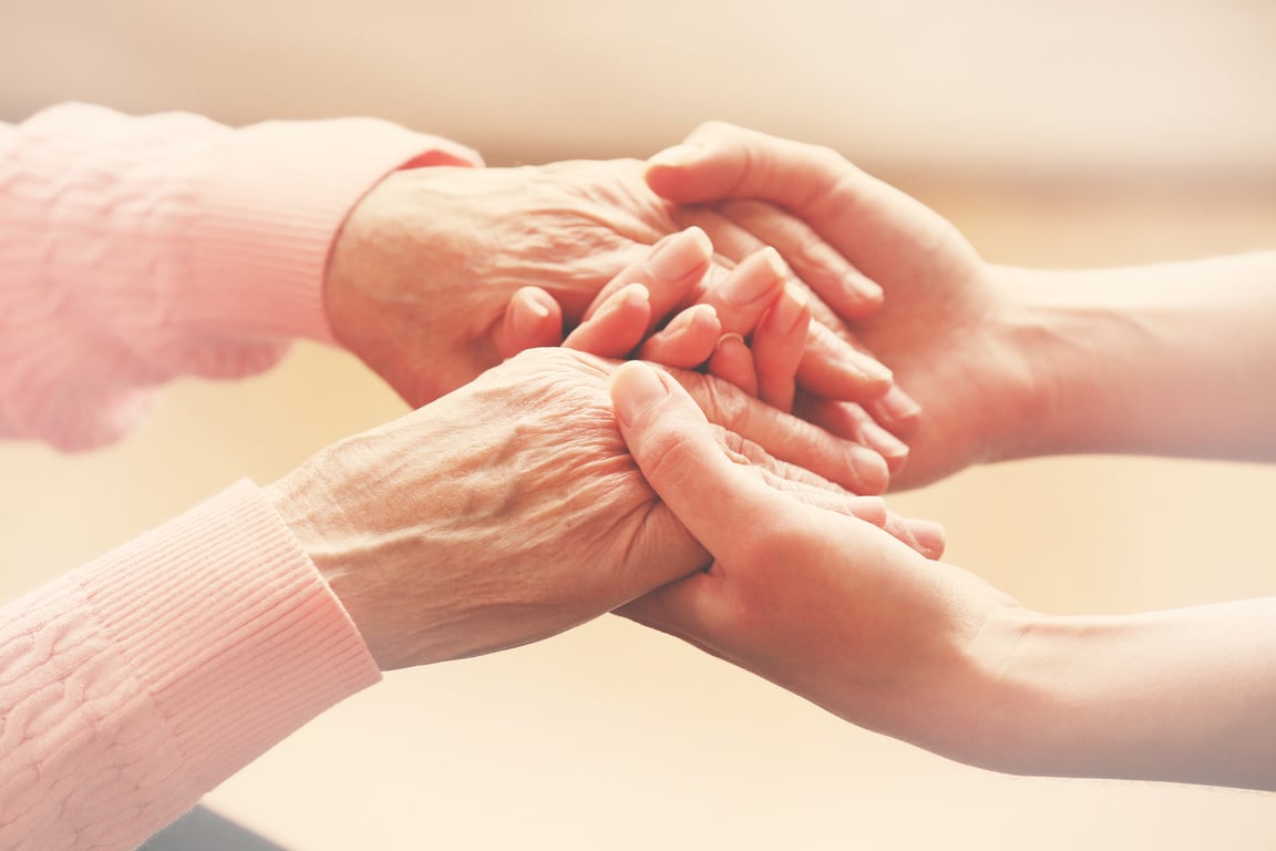 Young and Elderly Holding Hands